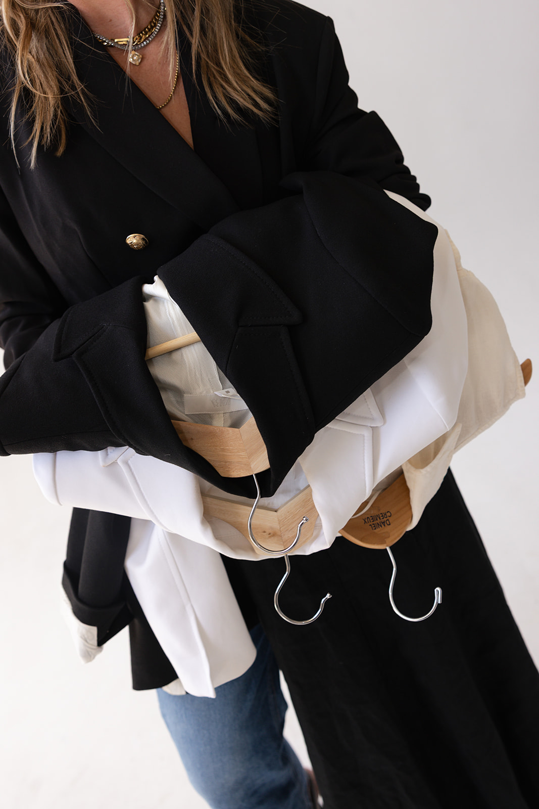 Callie with arms full of hangers — The Full Experience wardrobe build